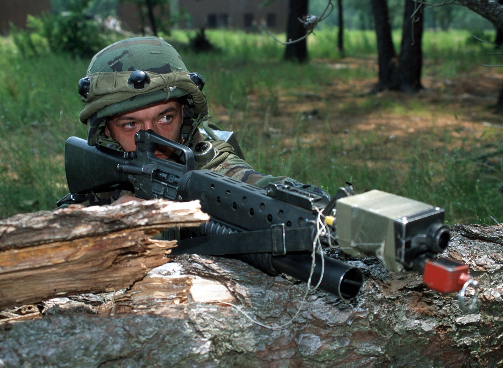 Scene Caption: Wearing a Multiple Integrated Laser Engagement System (MILES) gear and armed with an M16A2 assault rifle Airman First Class Jodey Powell with the 94th Security Forces Squadron, Dobbins Air Force Base, Georgia repels attacking opposition forces at a mock village on Fort Dix, New Jersey.