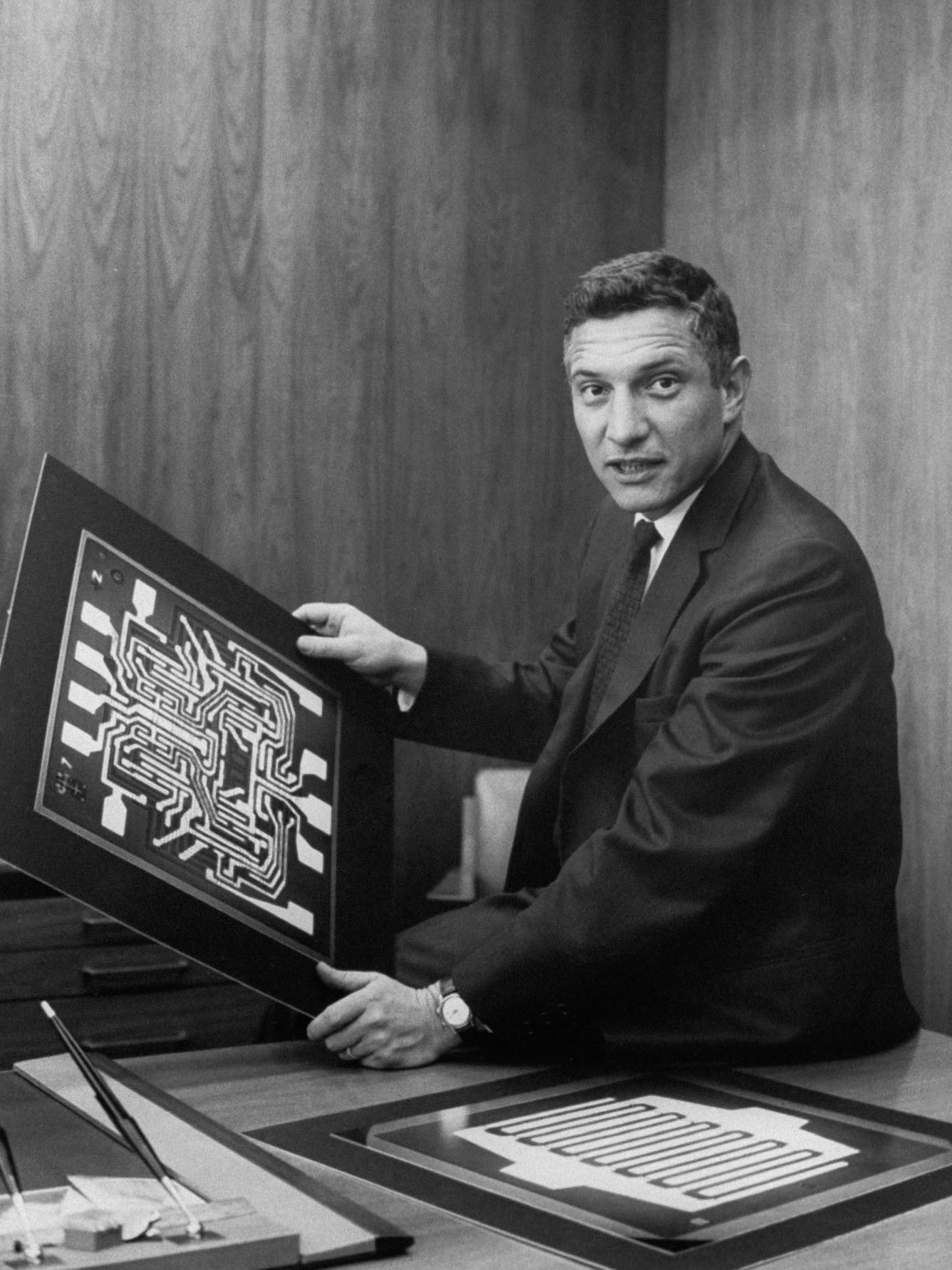 Fairchild Semiconductor division head Robert Noyce speaking in serious portrait in his office, w. diagrams of semiconductors & microchips. (Photo by Ted Streshinsky/Getty Images)